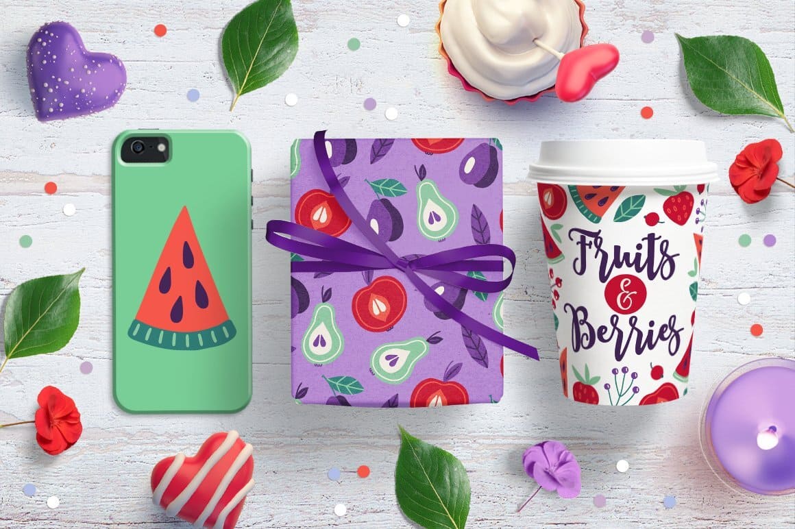 Using a pattern with fruits and berries in the design of a phone case and a coffee cup.