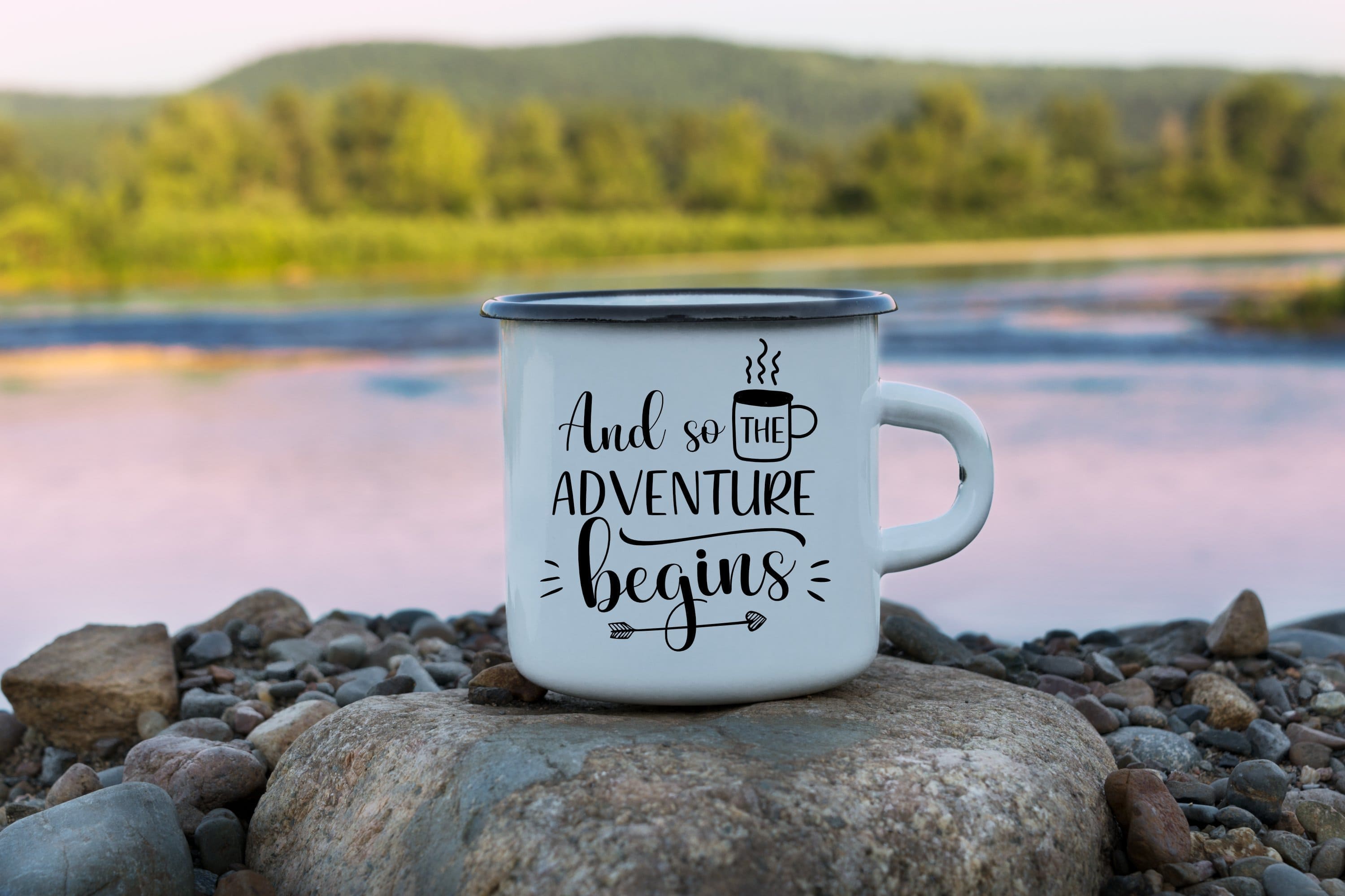 White mug with black and white print "It's time for a new Adventure" on the background of the river, forest and mountains.
