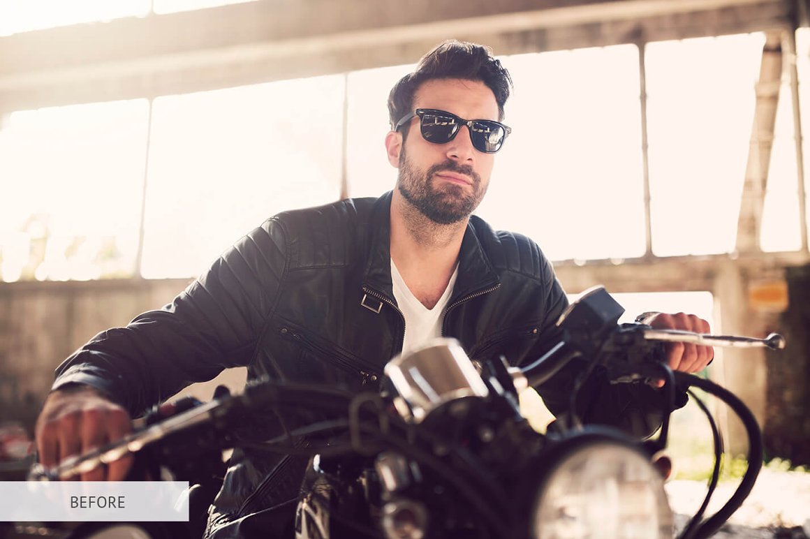 A guy on a motorcycle in black.