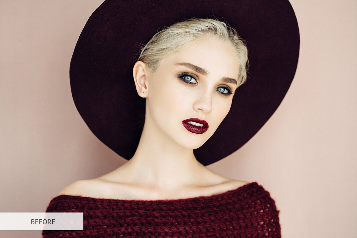 A big hat on the head of a girl in a burgundy sweater.