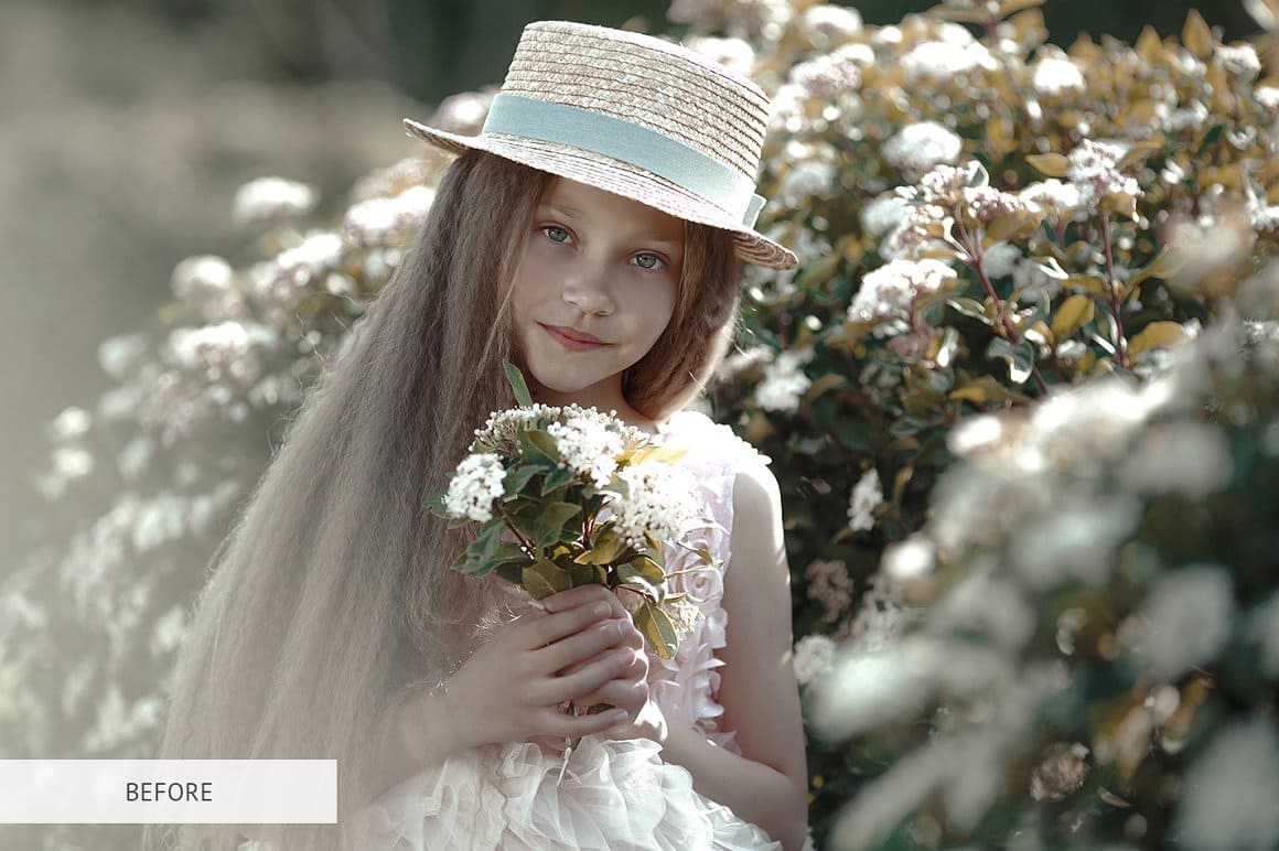 The girl holds a bouquet of bush flowers in her hands.