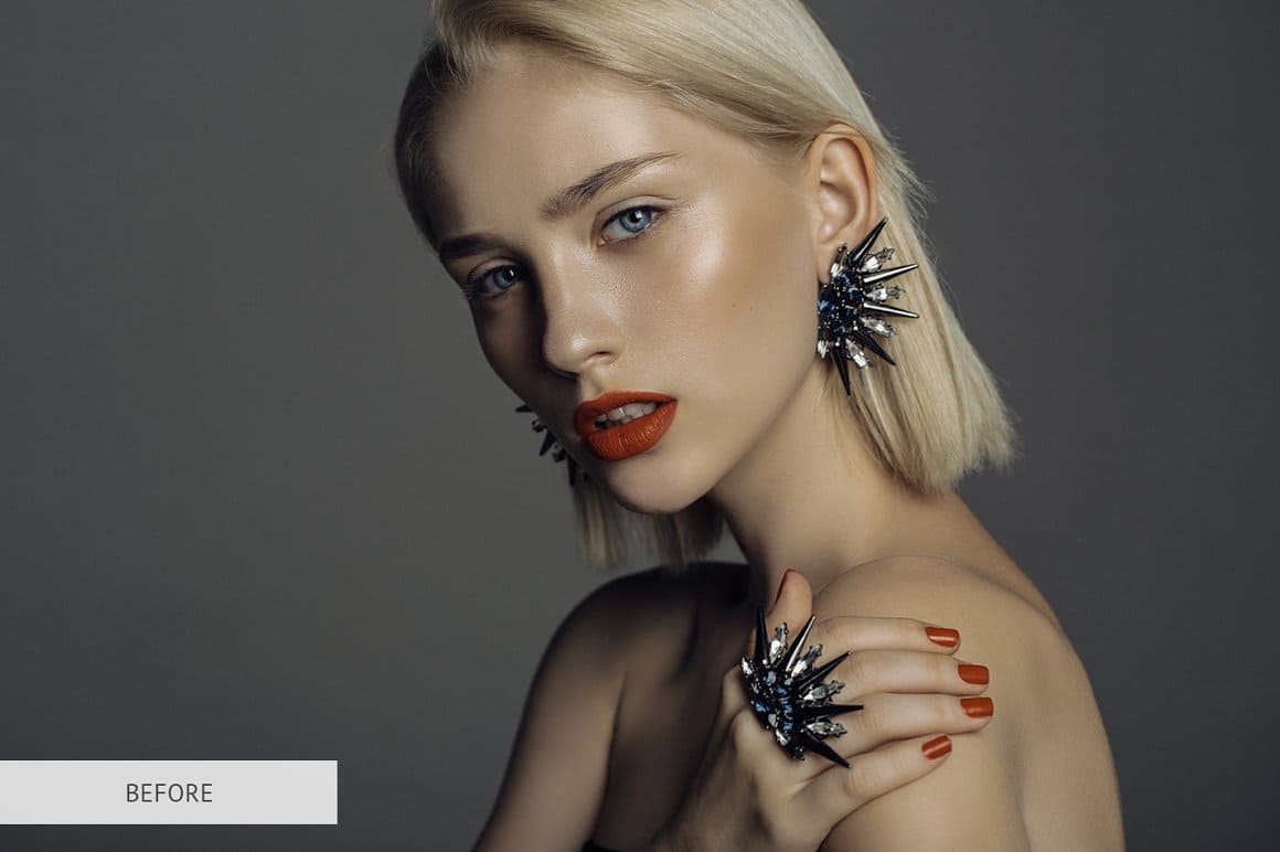 Image of a blonde girl with red lipstick and red nails with voluminous jewelry.