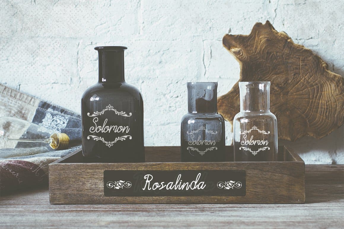 Labels with inscriptions in Acarita Script Font on glass jars.