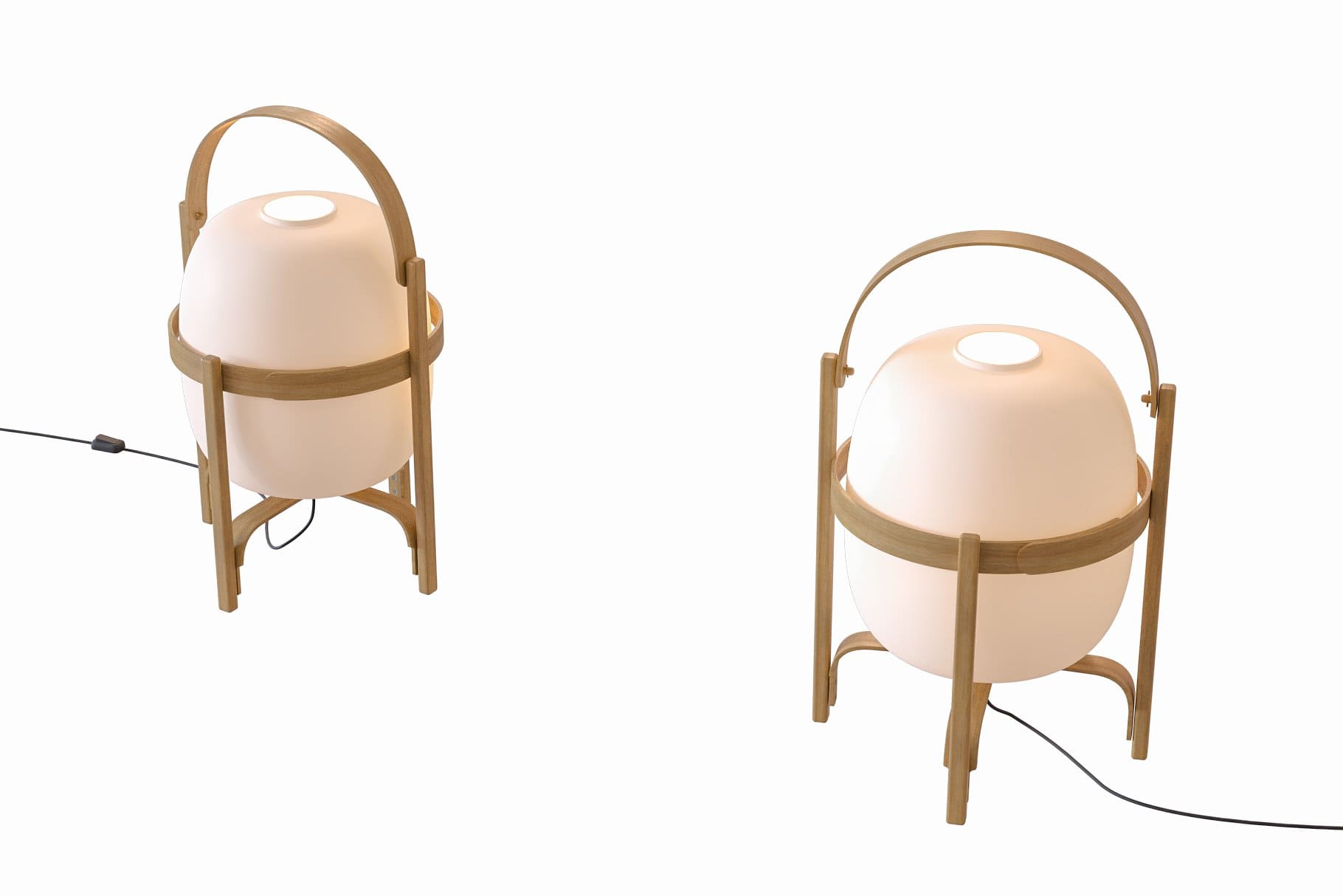 Two cesta table lamps stand on a white table.