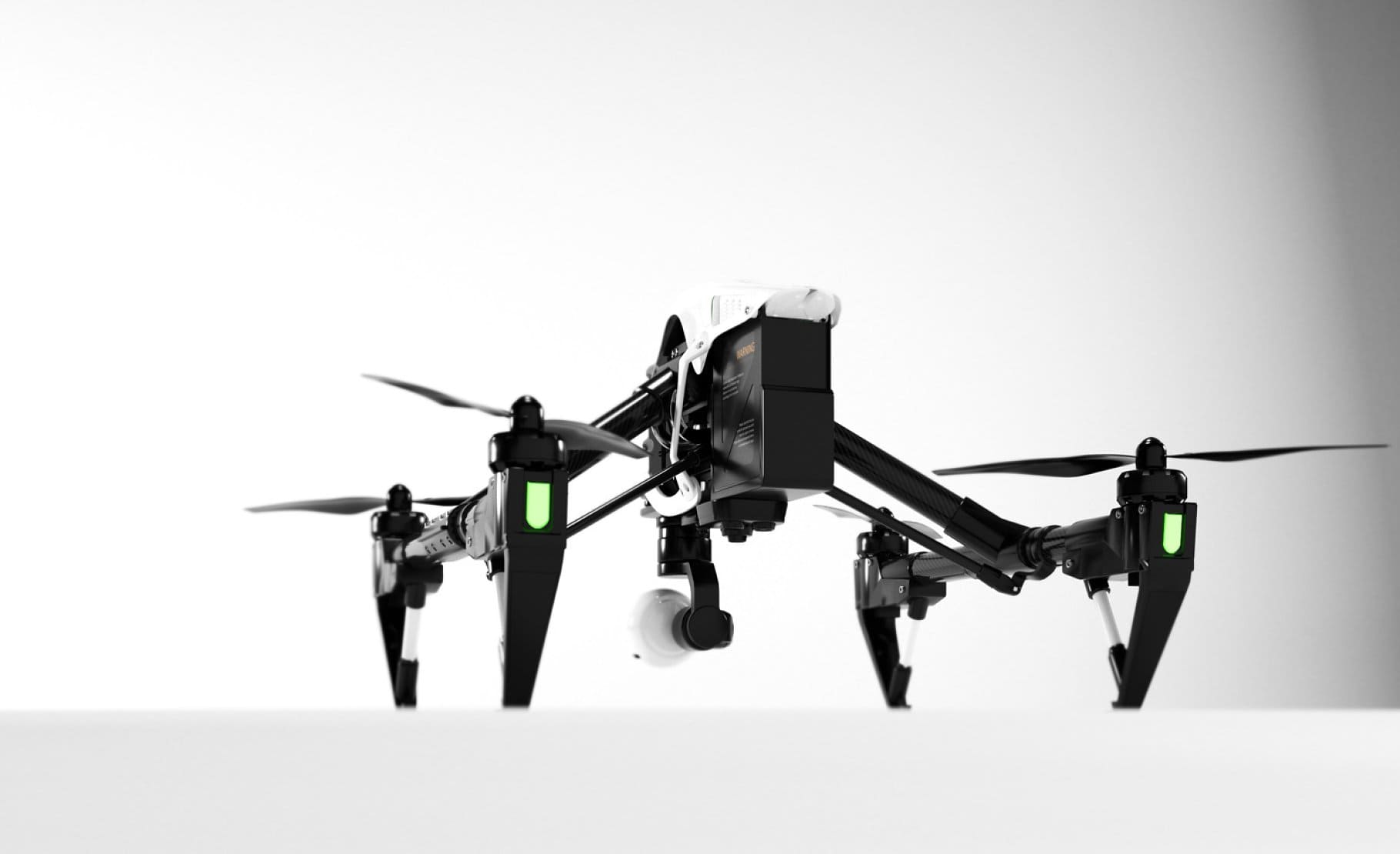 Black quadcopter with green lights that indicate the operation of the quadcopter.