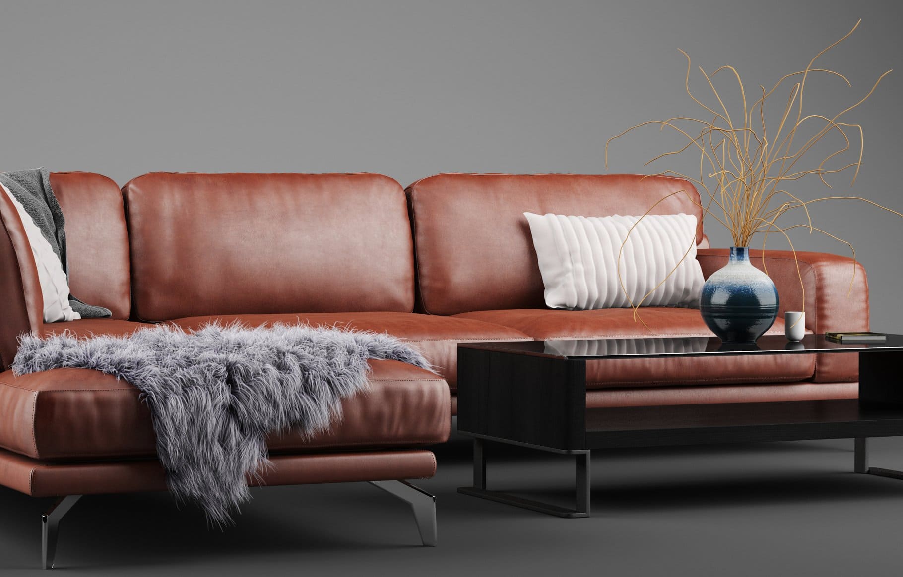 A wool blanket lies on the Peruna Leather Modular Sectional SOF.