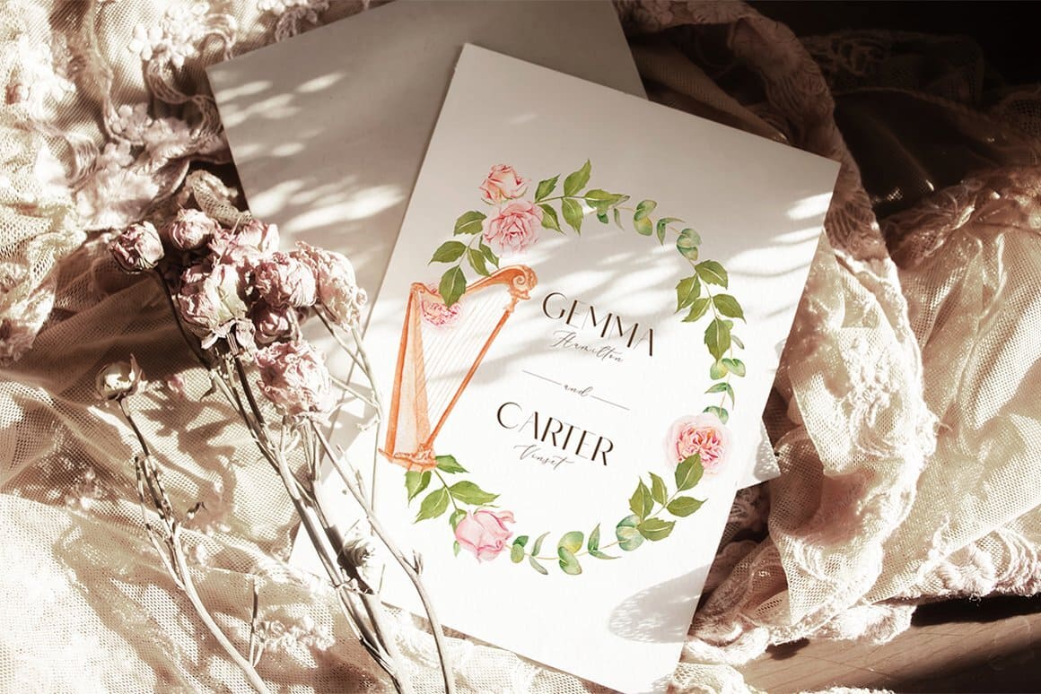 The wedding invitation is decorated with a pattern of a golden harp and rose flowers.