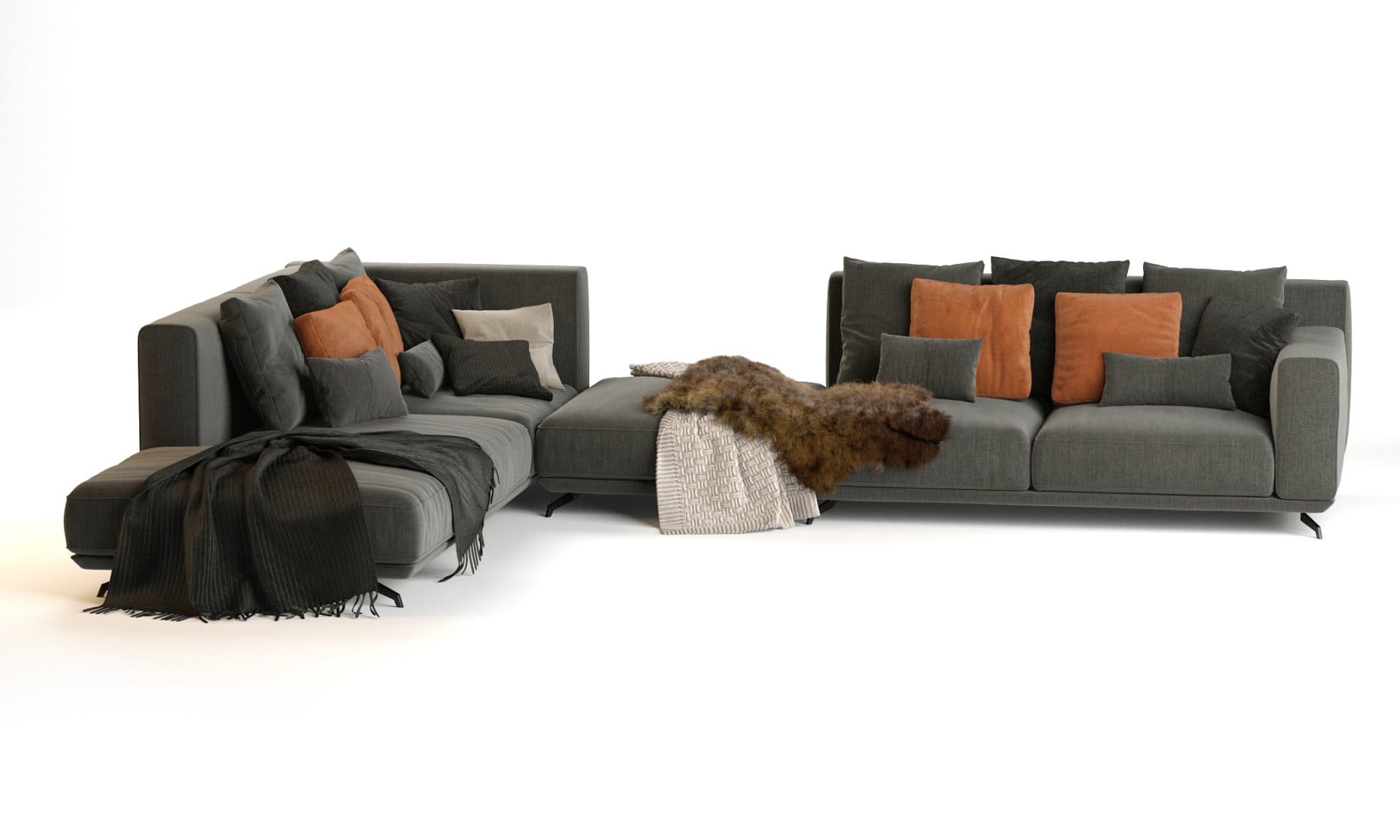 Pillows and blankets are laid out on the Dalton Sofa by Ditre Italia.