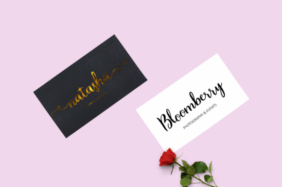 Black and white business cards and a rose in the image.