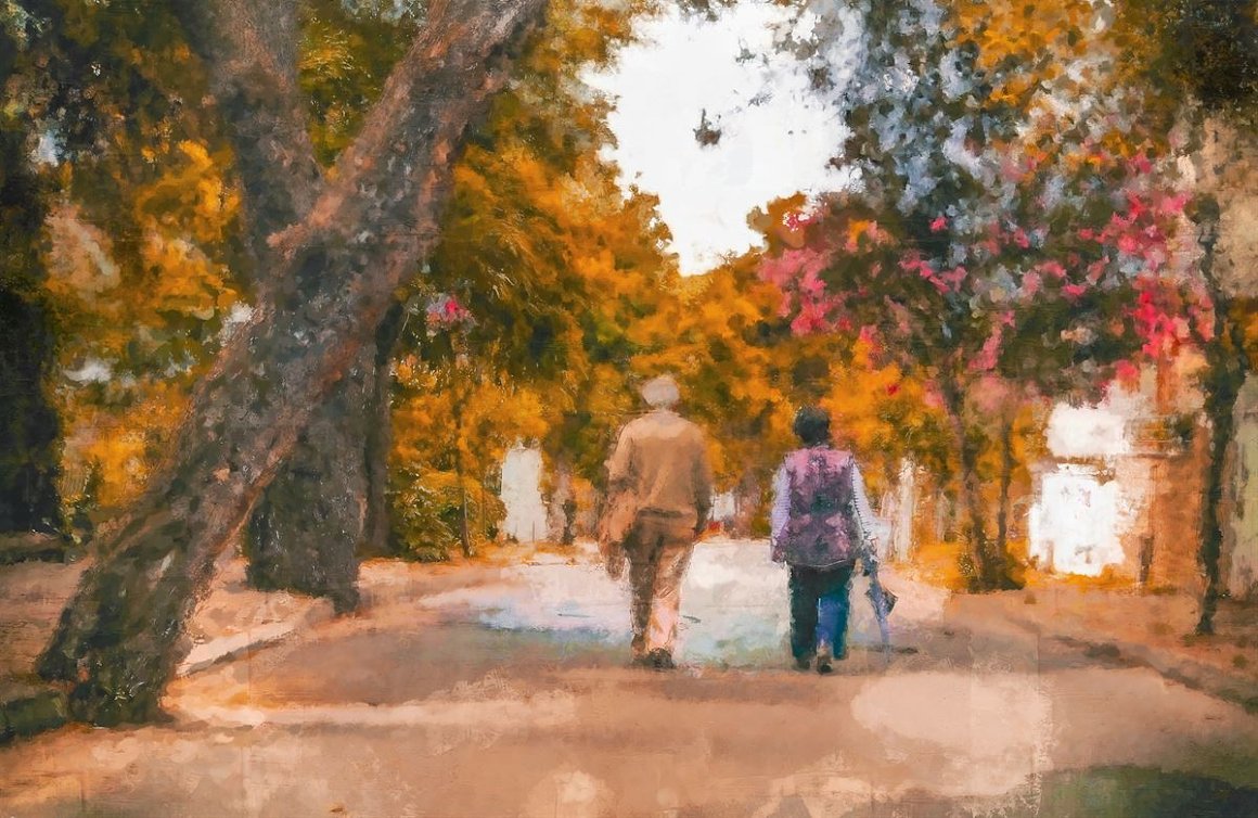 Grandfather and woman in the autumn park.