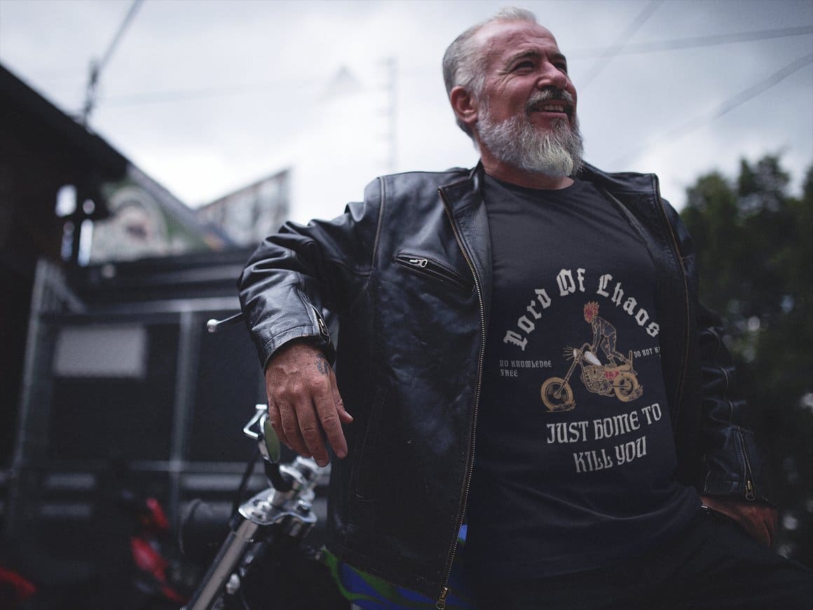 The aged motorcyclist wore a black t-shirt with the image of a motorcyclist riding a motorcycle.