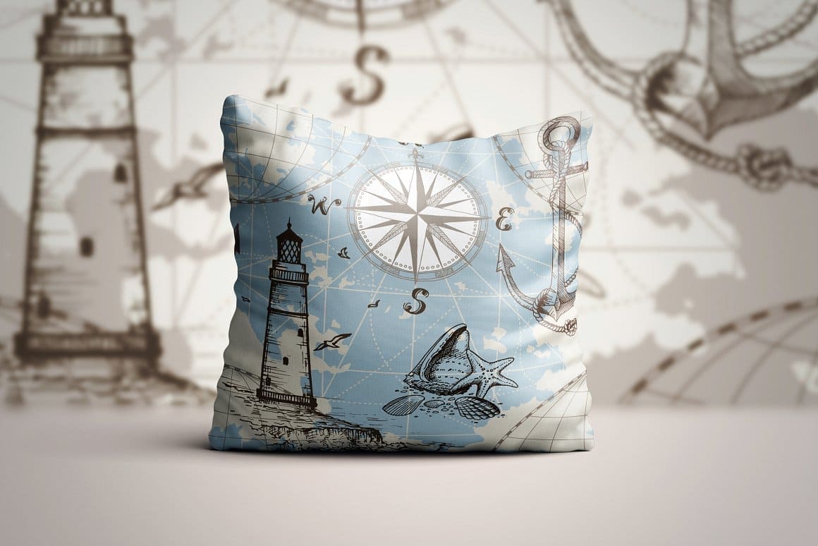A pillow with a marine print, an image of a lighthouse, anchors, seagulls.