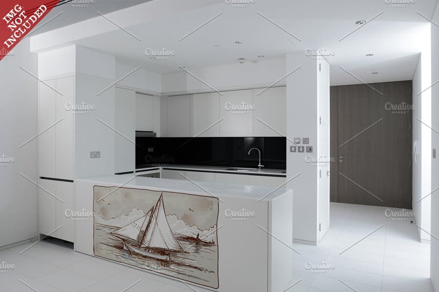 In the kitchen there is a designer table with an image of a sailing ship.